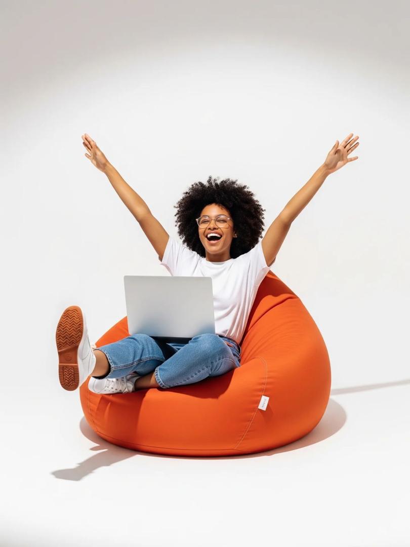 A young professional celebrating with a laptop